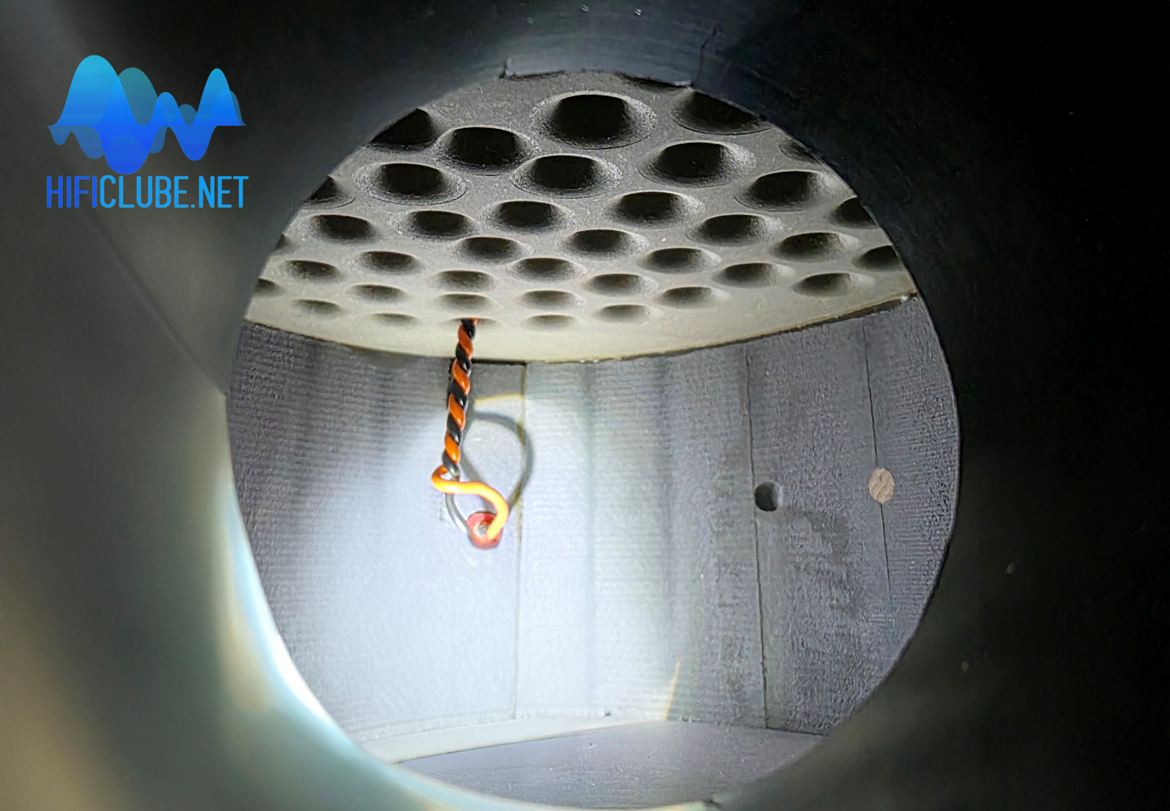 Interior of the reflex system's chamber. At the top, the perforated filter that divides the speaker chamber from the reflex port chamber. Photo by JVH.